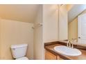 Powder room with a toilet, single vanity, and a large framed mirror on the wall at 17025 W Rimrock St, Surprise, AZ 85388