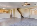 Open-concept room featuring tile flooring, carpeting, a staircase, and lots of space for entertaining at 17025 W Rimrock St, Surprise, AZ 85388