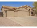 Charming single-story home with three-car garage, desert landscaping and neutral paint at 1756 E Cardinal Dr, Casa Grande, AZ 85122