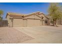 Charming single-story home with three-car garage, desert landscaping and neutral paint at 1756 E Cardinal Dr, Casa Grande, AZ 85122