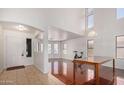 Bright living room with tile flooring, abundant natural light from multiple windows, and an open floor plan at 1805 E Aloe Pl, Chandler, AZ 85286