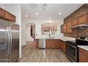 Modern kitchen with stainless steel appliances, tile backsplash, and tile floors at 1839 E Donner Dr, Phoenix, AZ 85042