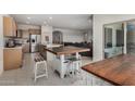 Spacious kitchen featuring an island, stainless steel appliances, and bar stool seating at 2373 N Riverside Dr, Florence, AZ 85132