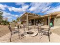 Backyard with a cozy fire pit area surrounded by chairs, perfect for relaxing evenings outdoors at 2712 S Tambor --, Mesa, AZ 85209