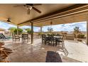 Inviting covered patio with an outdoor dining area and a built-in grill, ideal for entertaining at 2712 S Tambor --, Mesa, AZ 85209