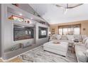 Bright living room featuring a modern fireplace, built-in shelves, and comfortable seating at 2712 S Tambor --, Mesa, AZ 85209