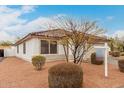 Charming single-story home with a tile roof, neutral stucco, and a two-car garage, set against a partly cloudy sky at 28617 N 50Th Pl, Cave Creek, AZ 85331