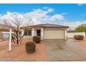 Charming single-story home with a tile roof, neutral stucco, and a two-car garage, set against a partly cloudy sky at 28617 N 50Th Pl, Cave Creek, AZ 85331