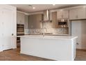 Modern kitchen featuring stainless steel appliances, a central island, and sleek gray cabinets at 40218 N Alegre Dr, San Tan Valley, AZ 85140