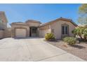 Spacious home with a three-car garage, desert landscaping and covered entry at 44383 W Windrose Dr, Maricopa, AZ 85138