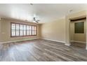 Open living room showcases light-colored walls, modern floors, and plantation shutters at 44383 W Windrose Dr, Maricopa, AZ 85138