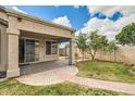 A covered patio extends the living space into the backyard, featuring a grassy area and block wall at 6198 W Wikieup Ln, Glendale, AZ 85308