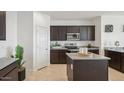 Modern kitchen featuring dark cabinets, granite countertops and stainless steel appliances at 636 W Freedom St, Florence, AZ 85132