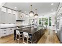 Spacious kitchen with marble island, white cabinets, and barstool seating at 6650 N Hillside Dr, Paradise Valley, AZ 85253