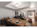 Open-concept dining area flowing into the living room with modern table setting and comfortable seating at 9355 N 91St St # 113, Scottsdale, AZ 85258