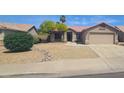 Charming home with a well-manicured front yard, desert landscaping, and a spacious two-car garage at 9654 N 94Th Ave, Peoria, AZ 85345