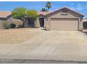 Single-story home with a tile roof, desert landscaping, and a two-car garage at 9654 N 94Th Ave, Peoria, AZ 85345