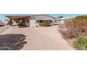 Single-story home with a large carport and xeriscaped front yard at 106 S 74Th St, Mesa, AZ 85208