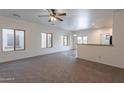 Bright living room with abundant natural light, neutral walls, and open layout to kitchen at 1100 E Canyon Trl, San Tan Valley, AZ 85143
