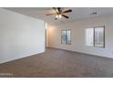 Spacious living room with neutral walls, soft carpeting, and ample space for furniture arrangement at 1100 E Canyon Trl, San Tan Valley, AZ 85143