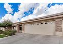 Single-story home featuring a wide driveway, stone pillar accents, and desert landscaping, located in a quiet neighborhood at 11069 E Kilarea Ave # 198, Mesa, AZ 85209