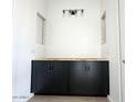 Bathroom vanity with dark cabinets, ready for countertop install at 11426 E Utopia Ave, Mesa, AZ 85212