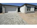 New construction with a large driveway and a two car garage at 11426 E Utopia Ave, Mesa, AZ 85212