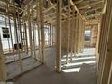 Interior view showing the framing of a new home, highlighting the open floor plan and construction progress at 11426 E Utopia Ave, Mesa, AZ 85212