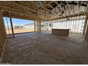 Interior view showing the framing of a new construction with outdoor views, focusing on the structural design at 11426 E Utopia Ave, Mesa, AZ 85212