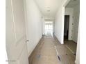 Hallway featuring wood-look tile floors, leading to a bright living space at 11426 E Utopia Ave, Mesa, AZ 85212