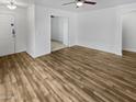 Spacious living room with wood flooring, ceiling fan, and open layout perfect for entertaining at 11734 W Paradise Dr, El Mirage, AZ 85335