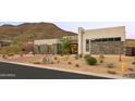 Modern home featuring desert landscaping, stone accents, and mountain views at 14102 E Sonora Crest Dr, Fountain Hills, AZ 85268