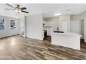 Open concept living space featuring wood-look floors, a kitchen island and a ceiling fan at 1420 E Sonrisas St, Phoenix, AZ 85040