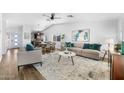 Bright living room with hardwood floors, a ceiling fan, and an open layout at 1525 W Mcnair St, Chandler, AZ 85224