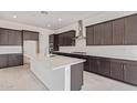 Modern kitchen features sleek stainless steel appliances and large center island at 15822 W Bronco Trl, Surprise, AZ 85387