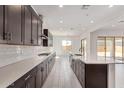 Bright, spacious kitchen with stainless steel appliances and a central island at 15822 W Bronco Trl, Surprise, AZ 85387