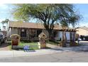 Single-story home features manicured front yard with decorative wooden well and arbor at 17648 N 36Th St, Phoenix, AZ 85032