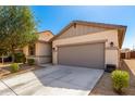 Charming single-story home featuring a neutral color scheme, well-maintained landscaping, and a spacious two-car garage at 18069 W Tina Ln, Surprise, AZ 85387