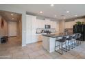 Spacious kitchen featuring white cabinets, a large island with seating, and modern stainless steel appliances at 18187 W Via Montoya Dr, Surprise, AZ 85387