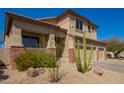 Inviting home featuring brick accents, a covered porch, and low-maintenance desert landscaping at 22236 N 48Th St, Phoenix, AZ 85054