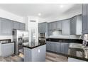 Modern kitchen with granite countertops, stainless steel appliances, and stylish gray cabinets at 22236 N 48Th St, Phoenix, AZ 85054