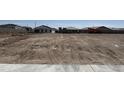Developing land showing the initial construction, including framed houses in a construction area at 24091 W Bowker St, Buckeye, AZ 85326