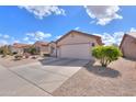 Attractive home with desert landscaping, a large driveway, and a neutral stucco exterior at 2453 E Hancock Trl, Casa Grande, AZ 85194