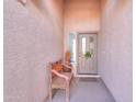 Cozy front porch with a bench, potted plants, a decorative wreath and an inviting front door at 2453 E Hancock Trl, Casa Grande, AZ 85194