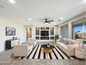 Bright and airy living room with neutral tones, modern furniture, and a built-in entertainment center at 2526 E Novak Way, Phoenix, AZ 85042