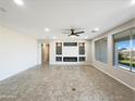 Spacious living room featuring neutral colors, a modern fireplace, and large windows for natural light at 2526 E Novak Way, Phoenix, AZ 85042