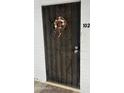 Inviting front door with black metal security screen at 2530 W Berridge Ln # E102, Phoenix, AZ 85017