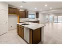 Modern kitchen with stainless steel appliances, dark cabinetry and a spacious island at 2658 N Coronado Dr, Florence, AZ 85132