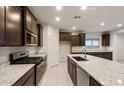Well-equipped kitchen boasting granite countertops, stainless steel appliances and dark cabinets at 2658 N Coronado Dr, Florence, AZ 85132