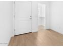 Bright entryway features wood-look tile, closet and white door at 2828 W Eagle Talon Rd, Phoenix, AZ 85085